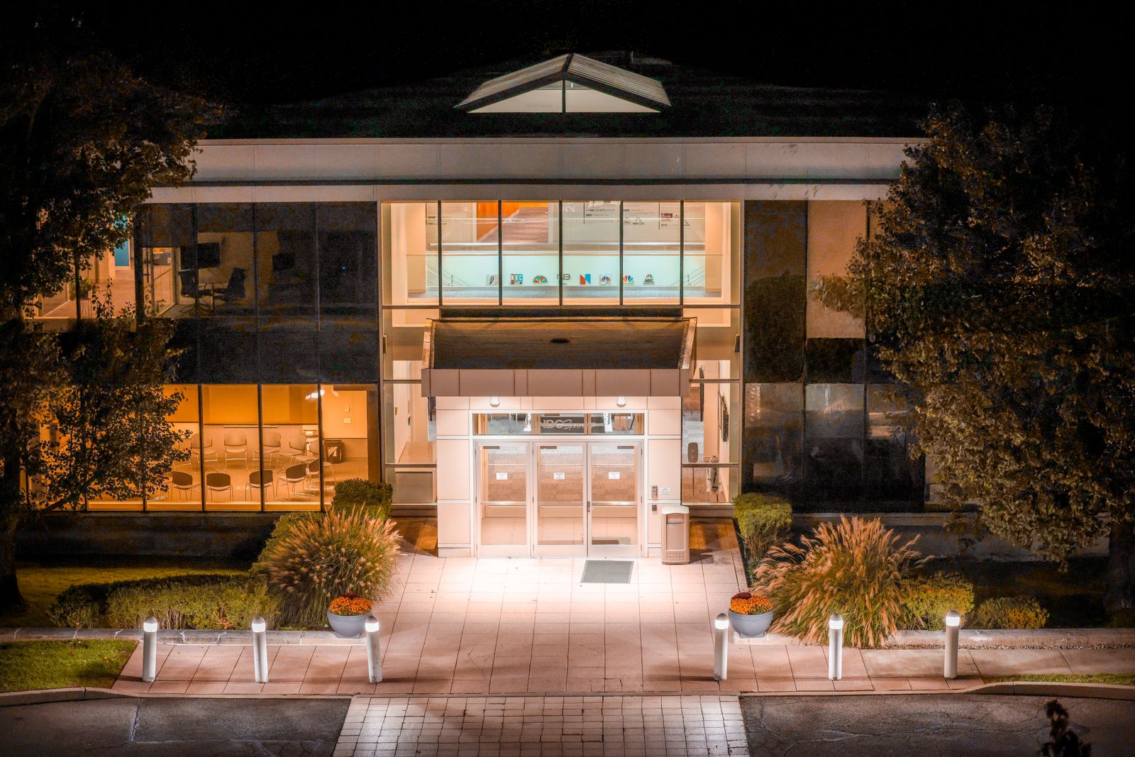 Illuminated modern office building facade in Stamford, Connecticut at night.